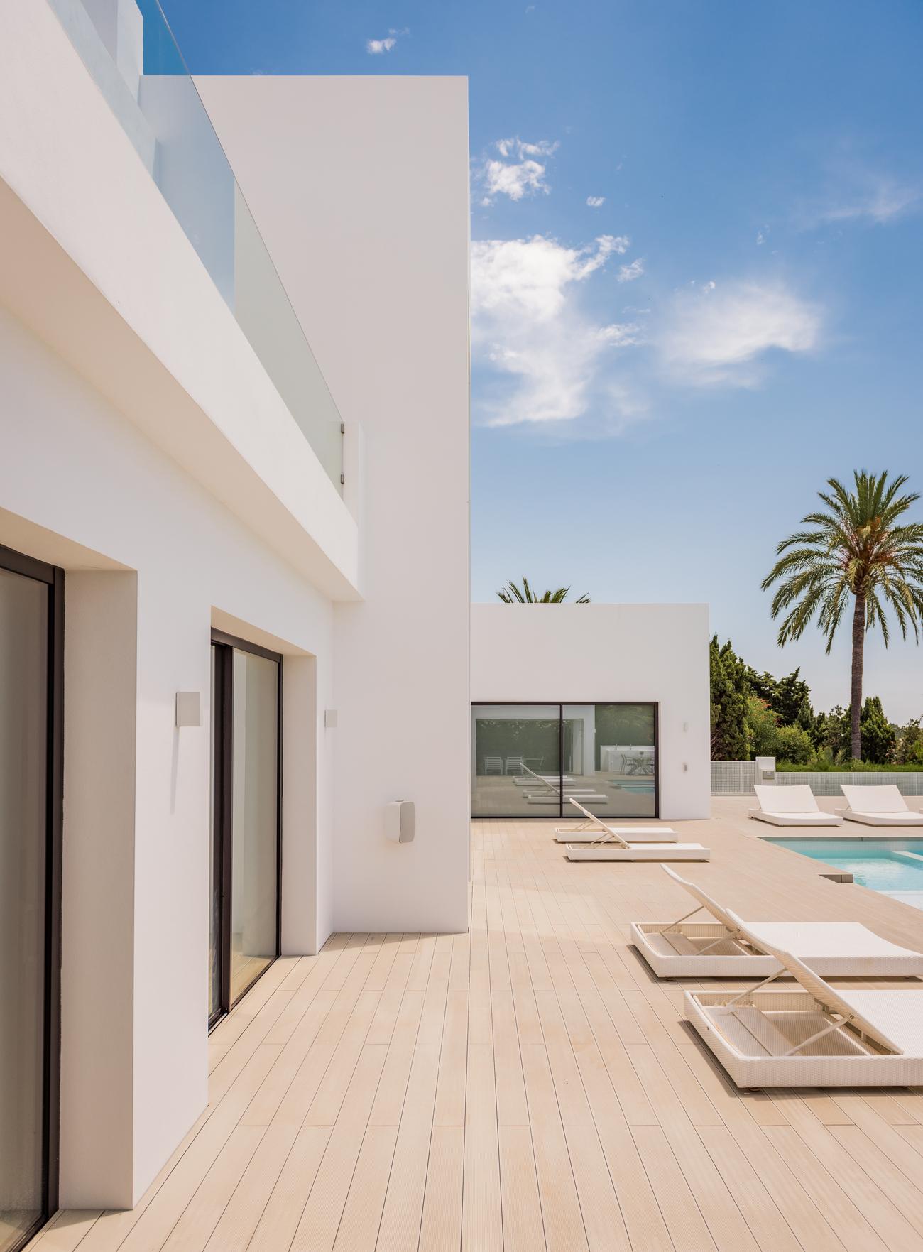 Side terrace at Villa El Pilar with a palm tree beyond